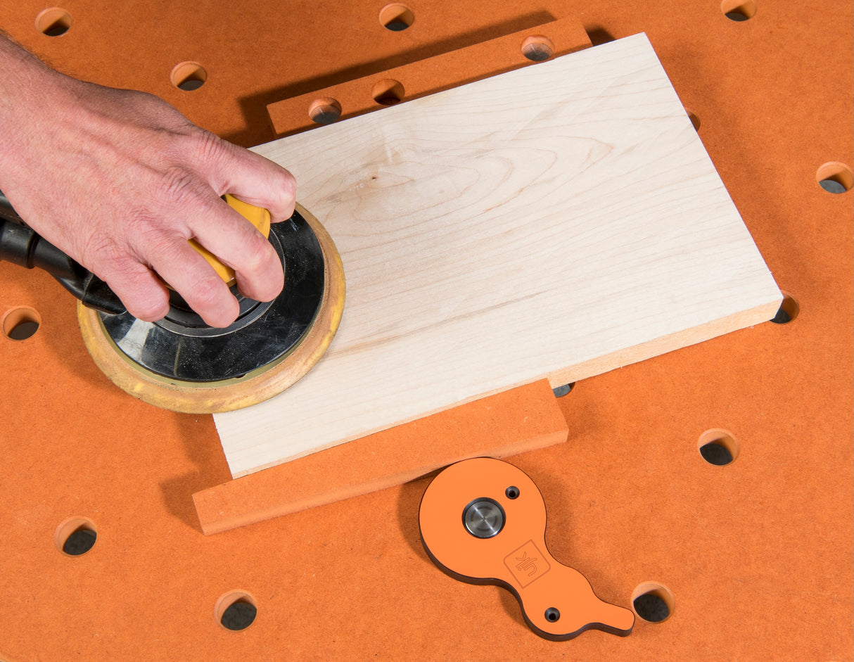 UJK Surface Cam Clamps securing workpiece on dog hole workbench surface