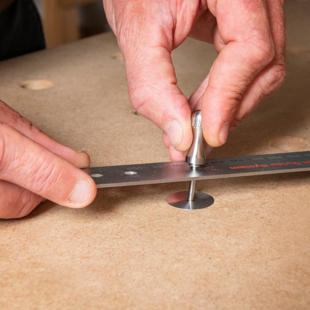 Three UJK Parf Aluminium Revision 20mm Bench Dogs with 3mm central hole, ideal for grid pattern expansion on multifunction bench top