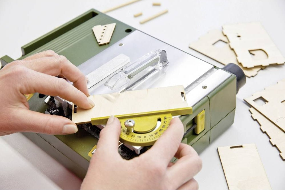PROXXON KS-230 Benchtop Mini Table Saw cutting intricate wood piece with precision and power