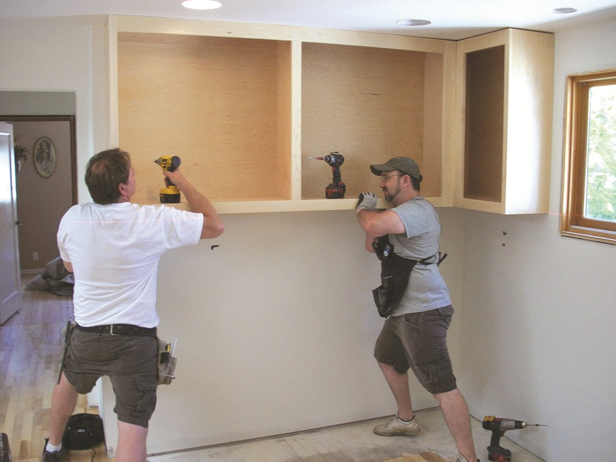 FastCap Upper Hand Cabinet Installation Support Poles in use for upper cabinet installation