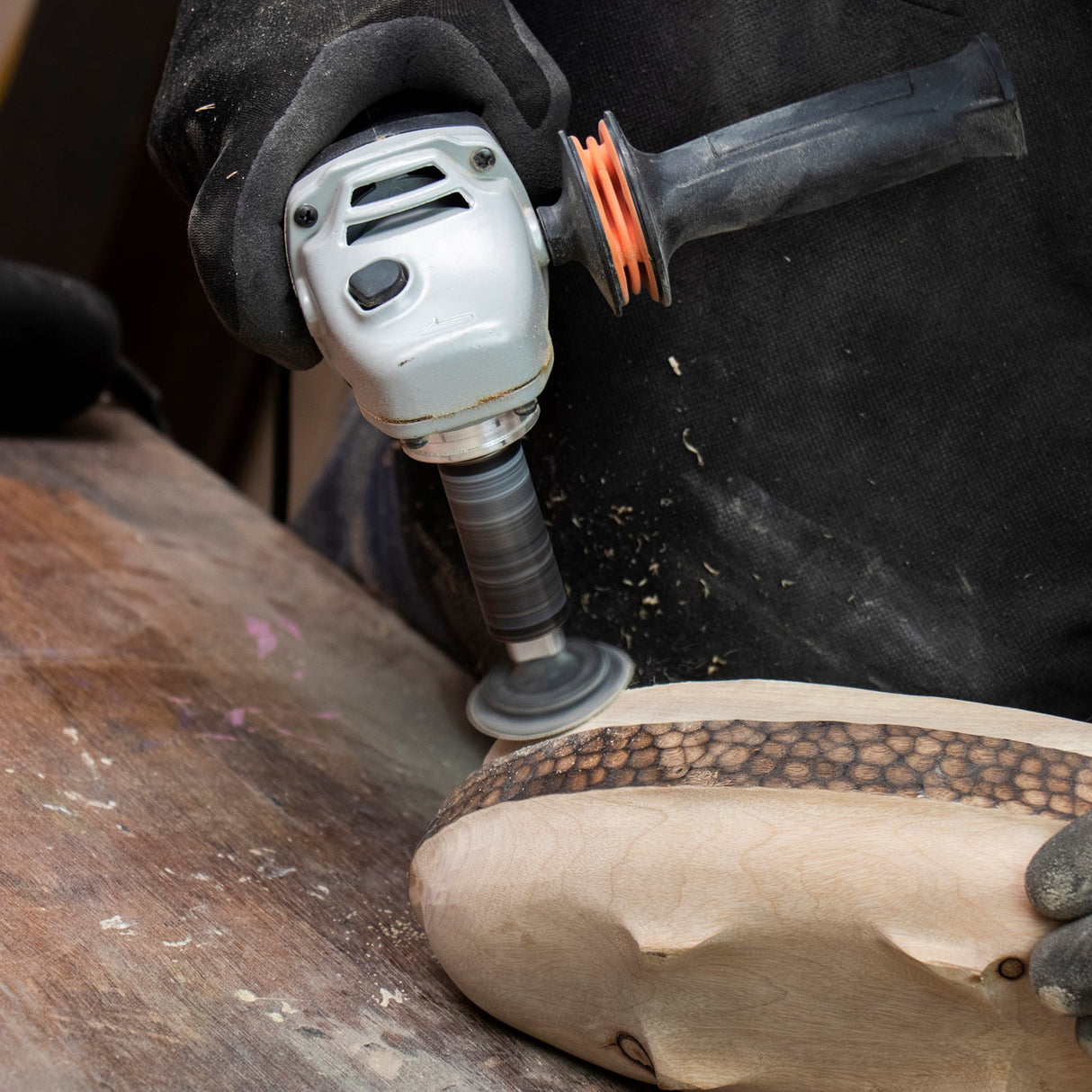 Arbortech Contour Sander attachment for M14 angle grinder with sanding discs in use on detailed woodwork