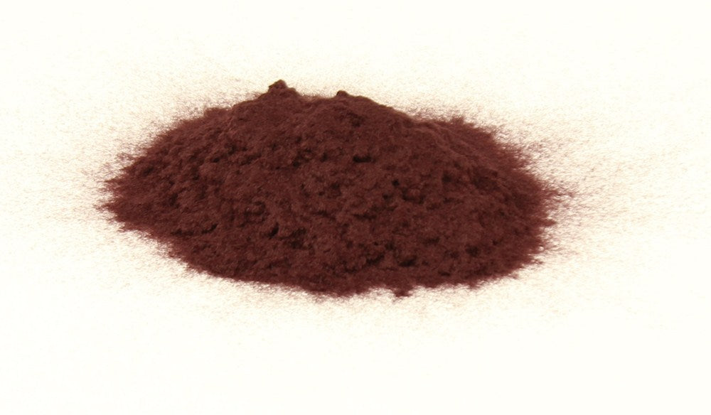 Burgundy flocking powder for woodworking craft projects on clear varnished timber surface