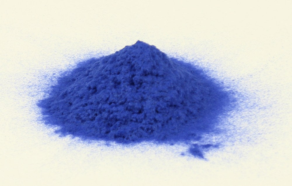 Royal blue flocking powder for woodworking projects, displayed in a clear container