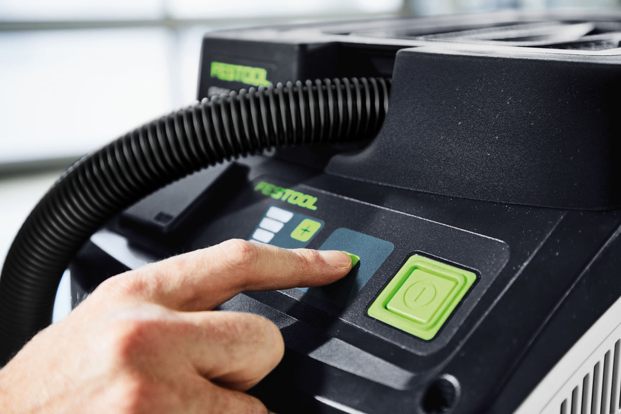 Festool CT 15L HEPA Class Dust Extractor in use at construction site, efficiently cleaning dust, dirt, and water