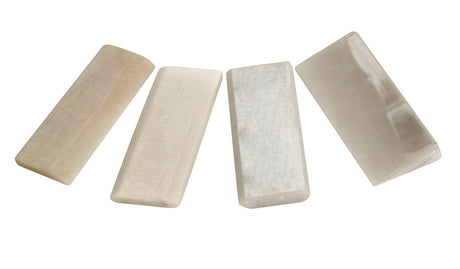 Four Arkansas sharpening stones for carving tools, in a cardboard display box. Natural stone cut, suitable for all chisel shapes