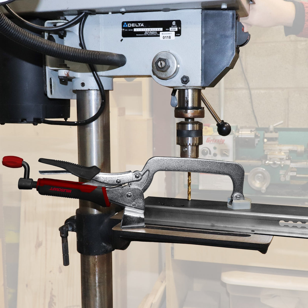 Milescraft Drill Press & Workbench Hold Down Clamps in action on drill press table