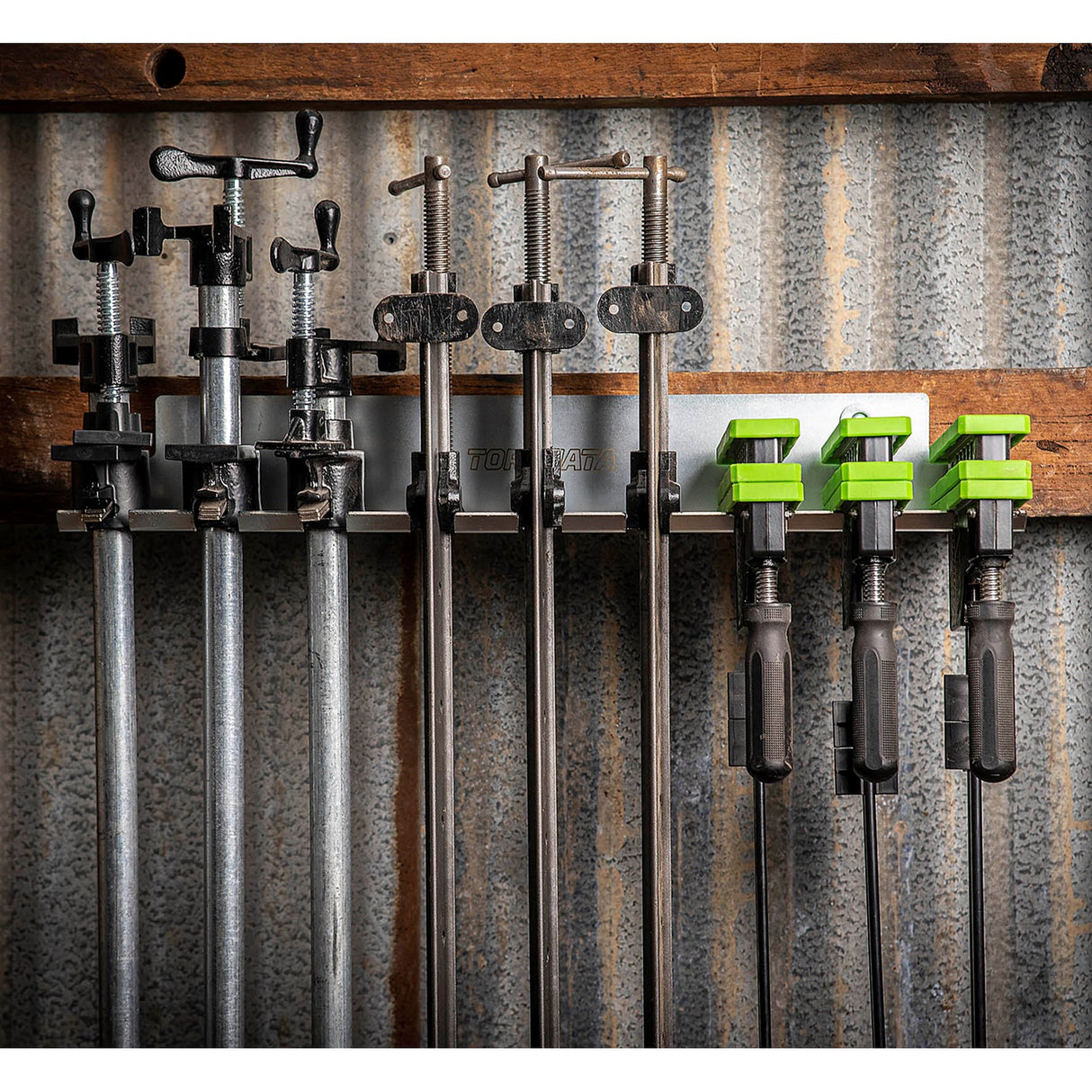 Torquata Steel Clamp Rack holding 9 pipe clamps on the wall