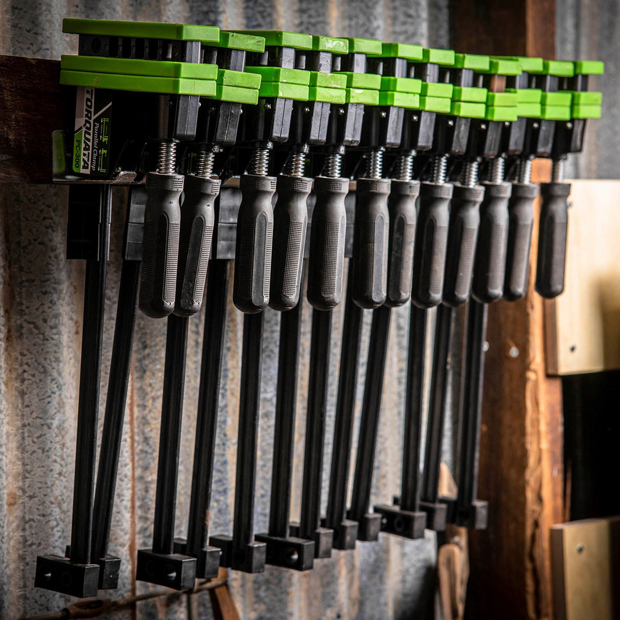 Torquata Set of 12 Parallel Clamps and Steel Wall Mounted Clamp Rack in workshop setting