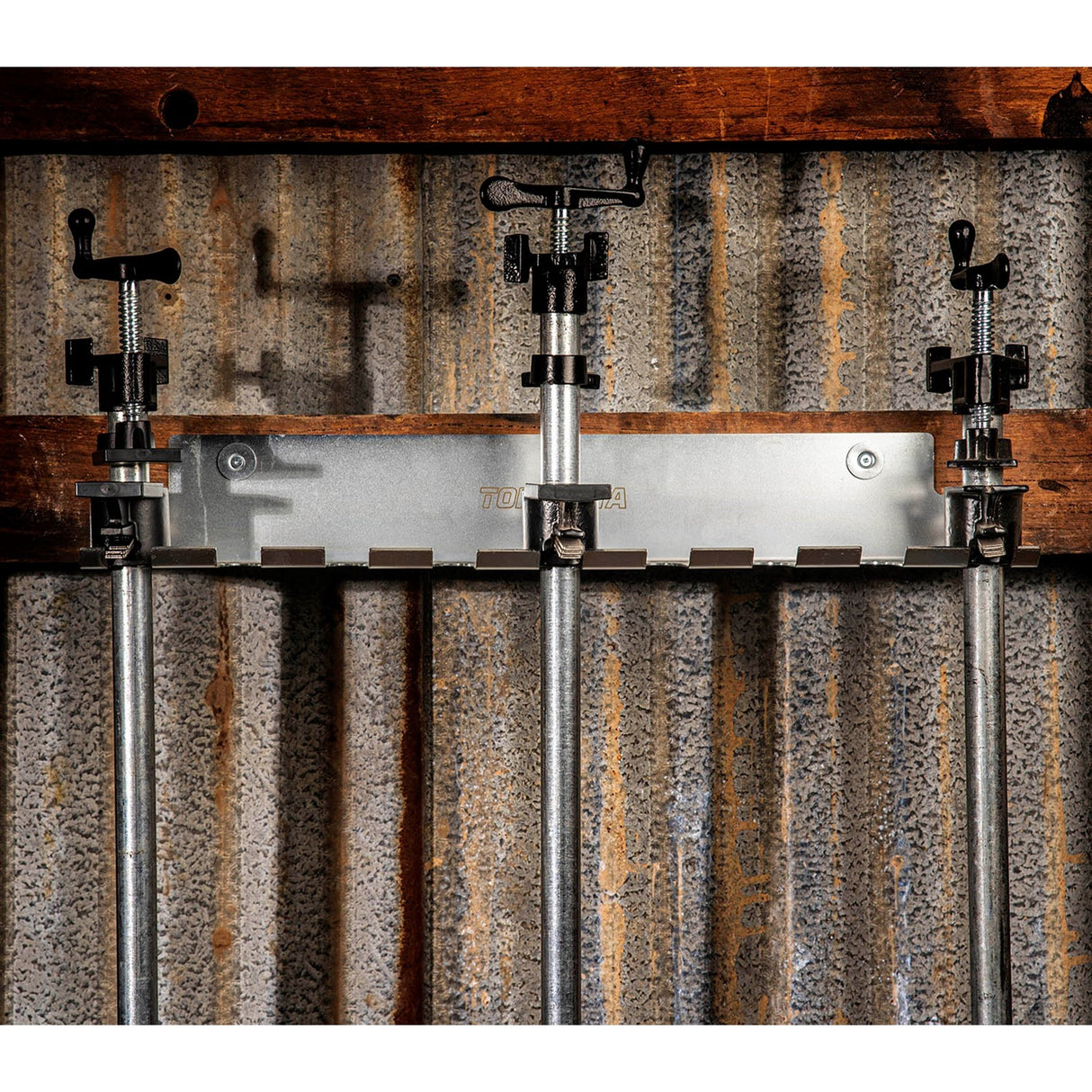 Torquata Set of 9 Long Pipe Clamps on Wall-Mounted Steel Rack