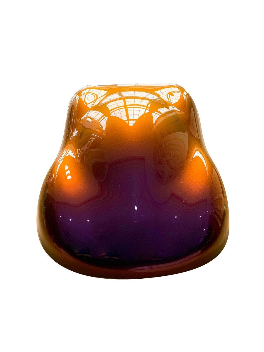 Purple, red, and gold chameleon mica pigment in epoxy resin jar on wooden surface