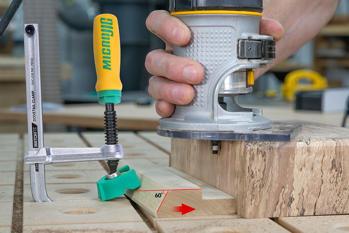 MicroJig X-Pad Clamp Cap for MatchFit Track Clamps, angled view with yellow clamp during routing operation