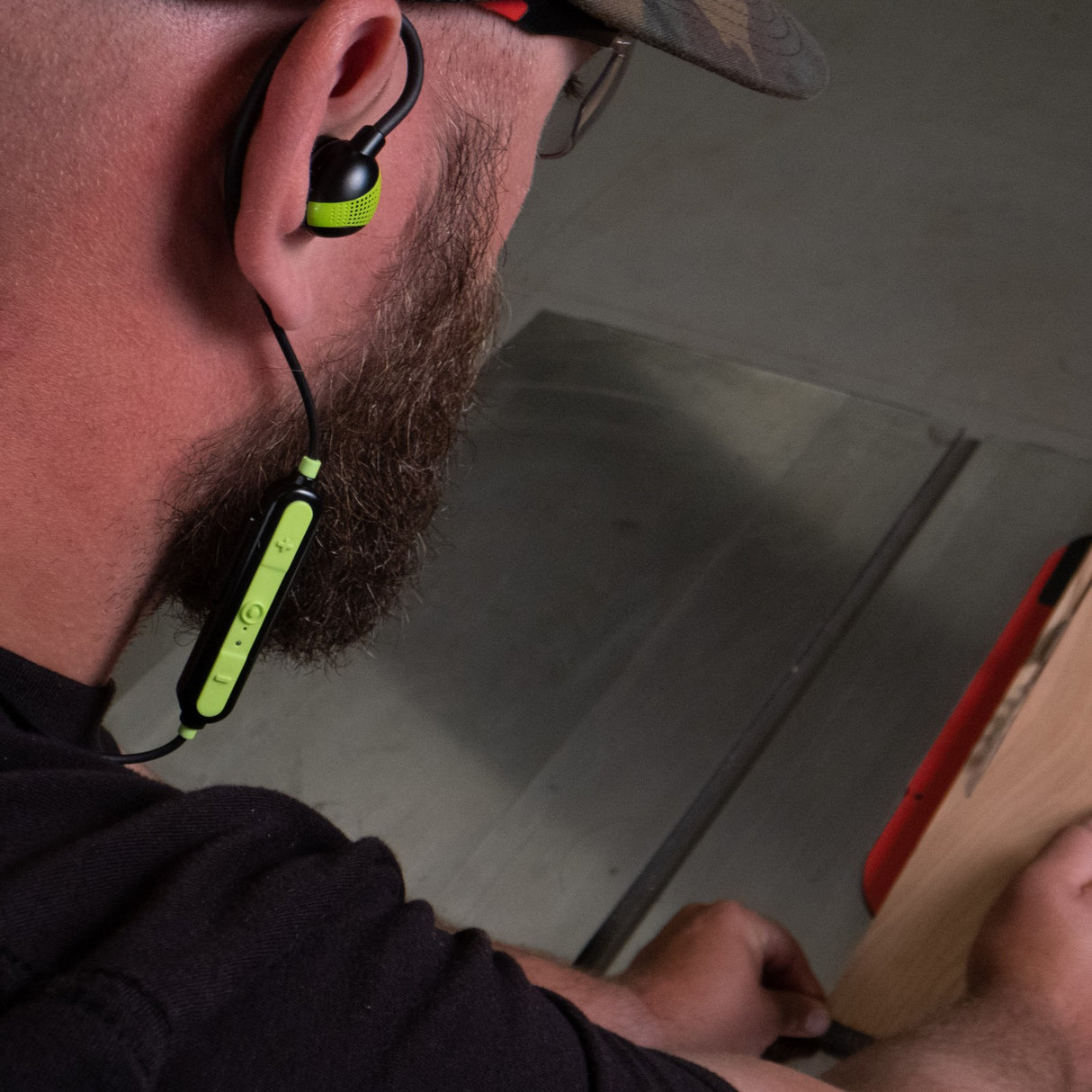 ISOtunes PRO Aware Bright Green Bluetooth Earbuds in workshop setting