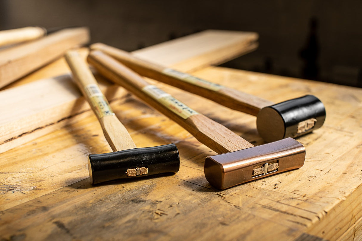 Three Japanese artisan hammers of different sizes and designs for woodworking tasks