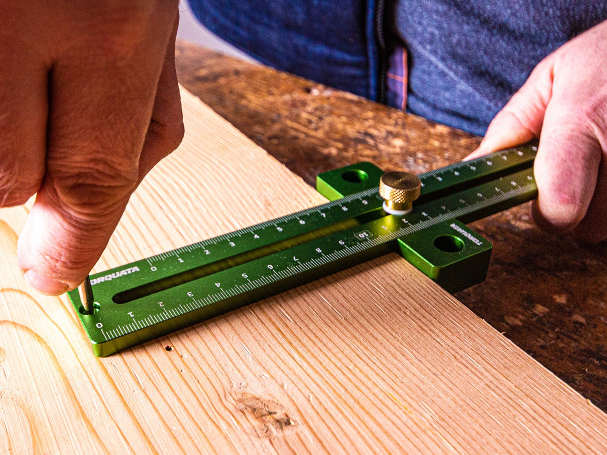Adjustable Torquata T-Rule woodworking tool showing precise measurement markings on a wooden surface