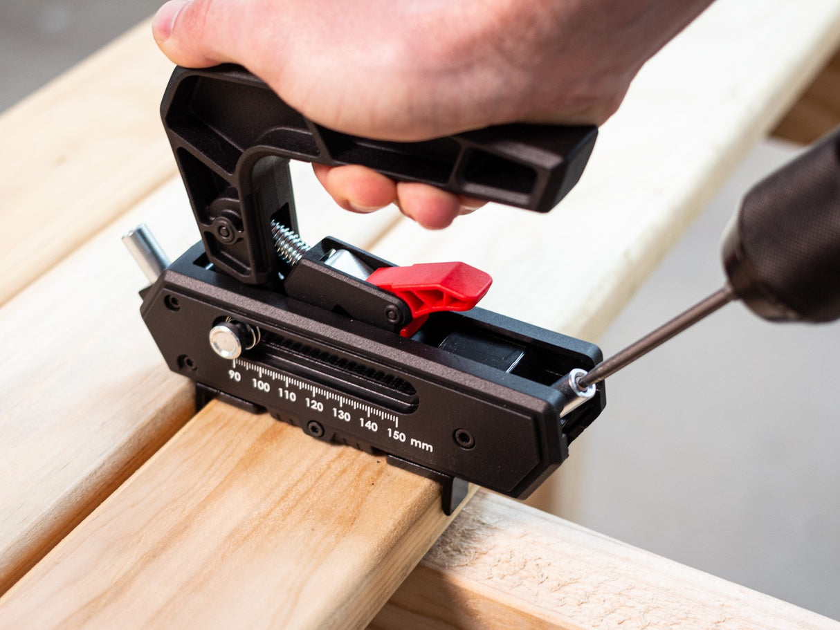 Torquata Concealed Screw Decking Jig in use, showing quick-release button and sliding mechanism