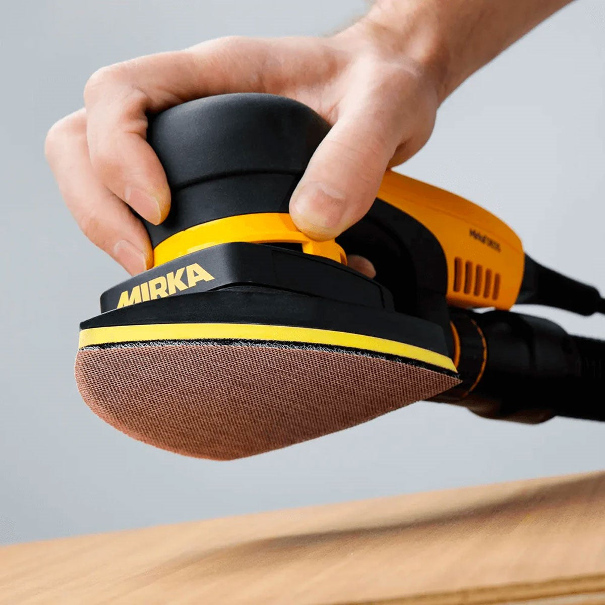 Mirka Abranet DEOS DELTA Sanding Sheet - 10 Pack, electric orbital sander accessory on wooden surface