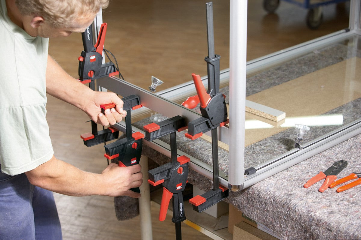 Bessey DuoKlamp 650mm Capacity woodworking tool in action, demonstrating easy switch between clamping and spreading functionalities