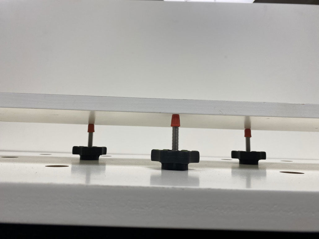 BOW Products Pack of Dogs Expandable Woodworking Bench Dogs in use with secure fixture placement on woodwork