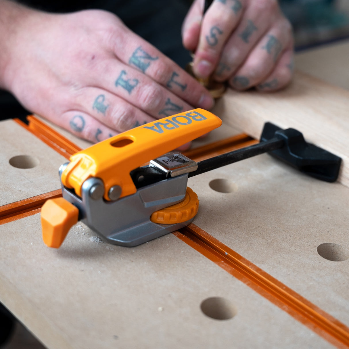 BORA Tool Auto Adjust Inline T-Track Toggle Clamp in use on woodworking project