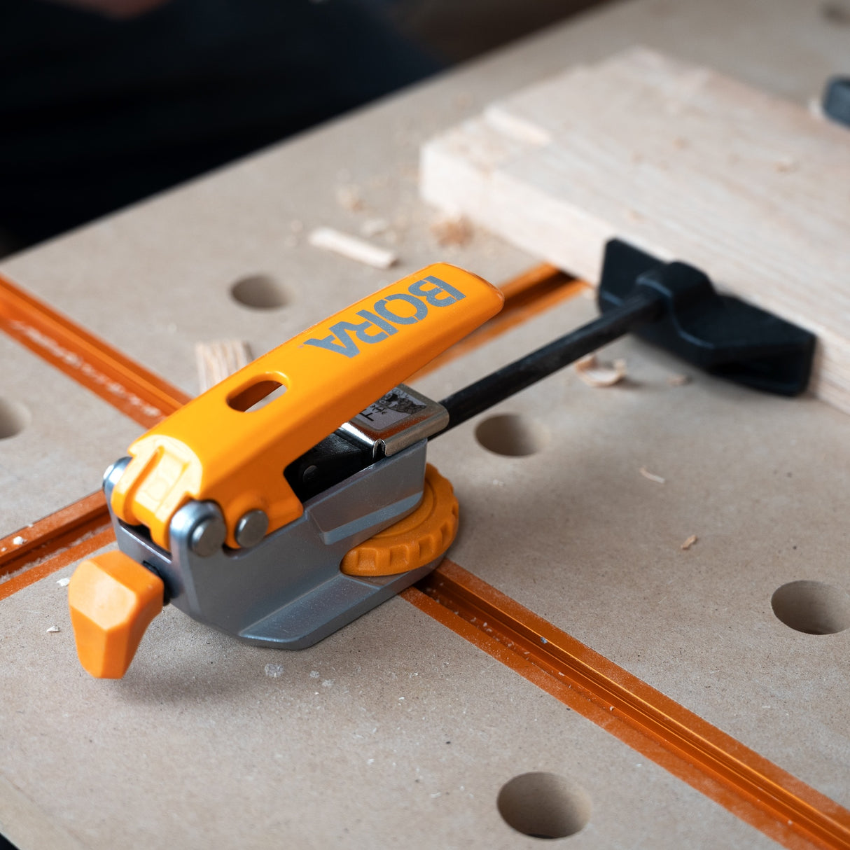 BORA Tool Auto Adjust Inline T-Track Toggle Clamp in action, ensuring secure and precise woodworking results
