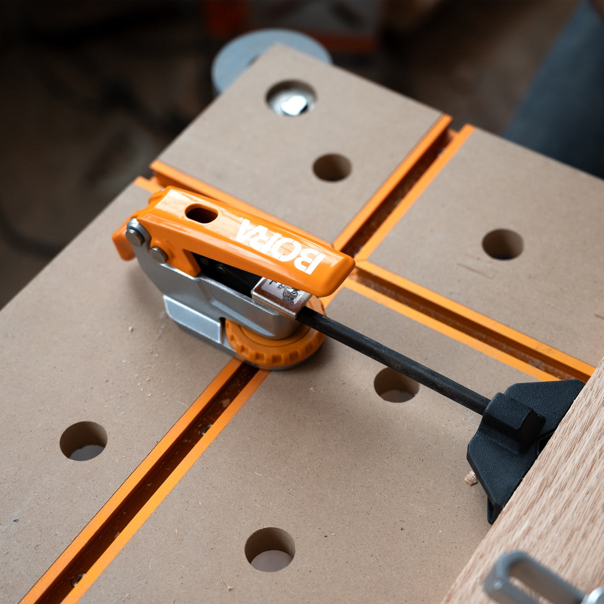 BORA Tool Auto Adjust Inline T-Track Toggle Clamp in use on woodworking project