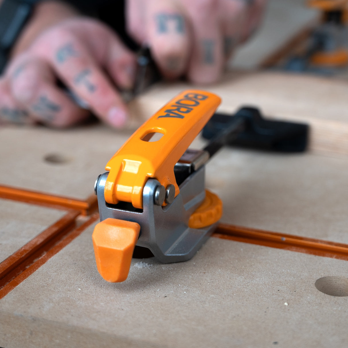 BORA Tool Auto Adjust Inline T-Track Toggle Clamp in use on woodworking project