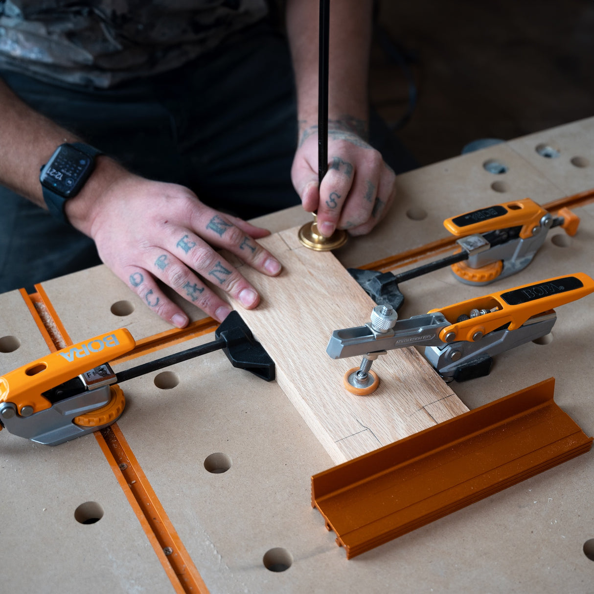 BORA Tool Dog Hole Auto Adjust Inline Toggle Clamp in use on a workbench, showcasing 90mm reach and 360-degree pivot capability
