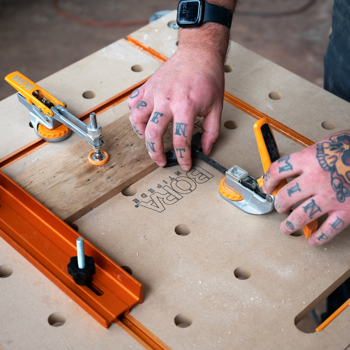 BORA Tool Dog Hole Auto Adjust Inline Toggle Clamp in action on workbench