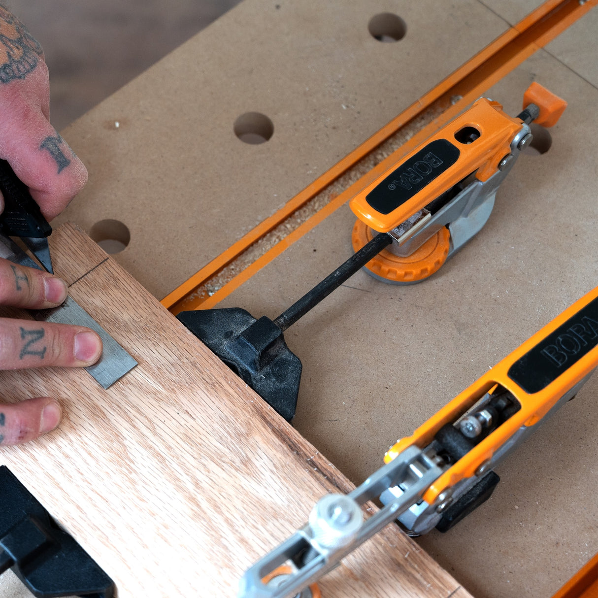 BORA Tool Dog Hole Auto Adjust Toggle Clamp in use on workbench