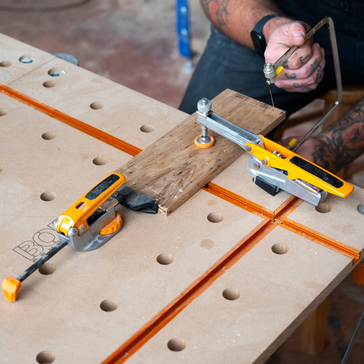 BORA Tool Dog Hole Auto Adjust Inline Toggle Clamp in action on workbench
