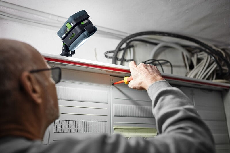 Compact yet powerful Festool SYSLITE KAL C cordless working light in action, illuminating narrow workspaces effectively