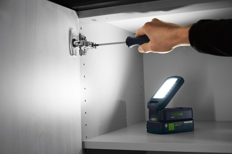 Compact cordless Festool SYSLITE KAL C working light illuminating narrow workspaces brilliantly