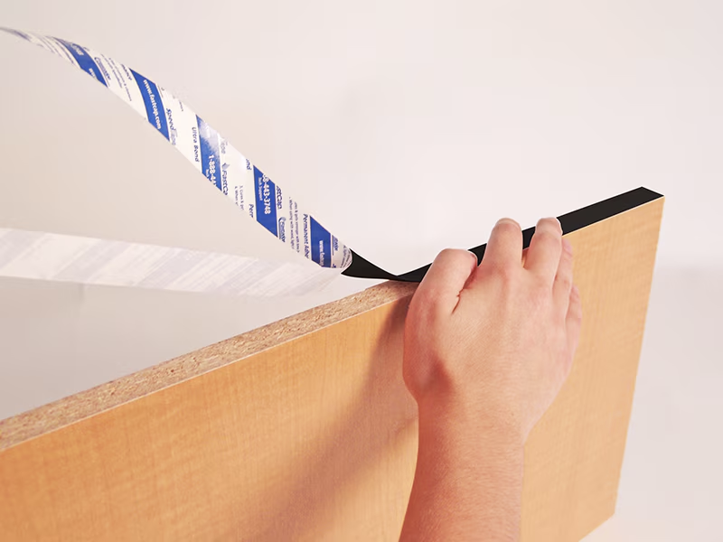 FastCap FastEdge Black PVC Peel and Stick Edge Banding 24mm Wide in use on cabinet edge