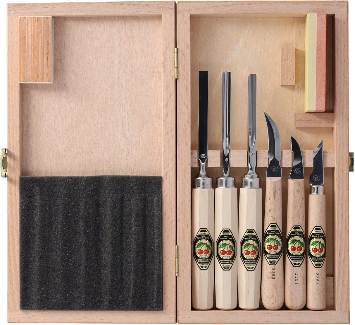 Set of six wooden carving tools and sharpening stone with branded labels in a wooden case.