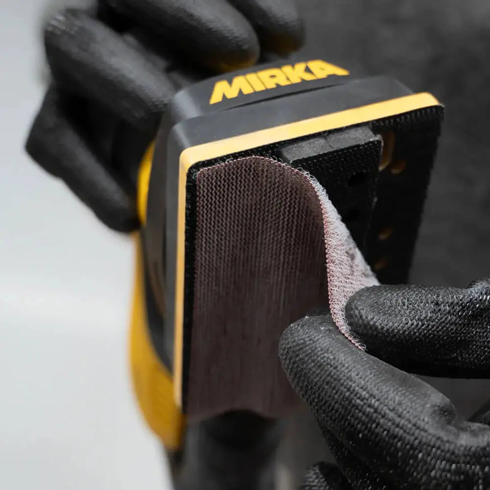 Mirka 6 x 12.5mm Soft Groove Interface Grip for DEOS Sanders in use on intricate woodworking surfaces