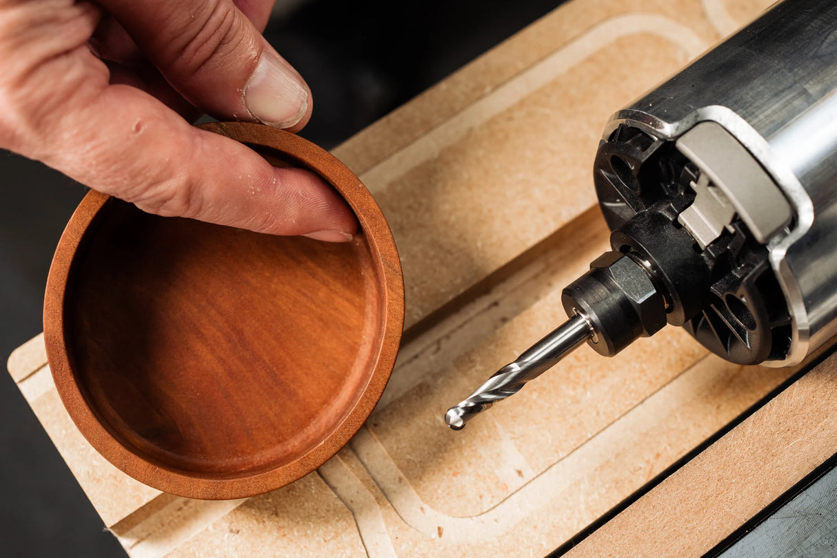 Solid carbide 1/4in x 3/4in Up-Spiral Ball Nose CNC Router Bit in action, ideal for cutting smooth channels in various materials