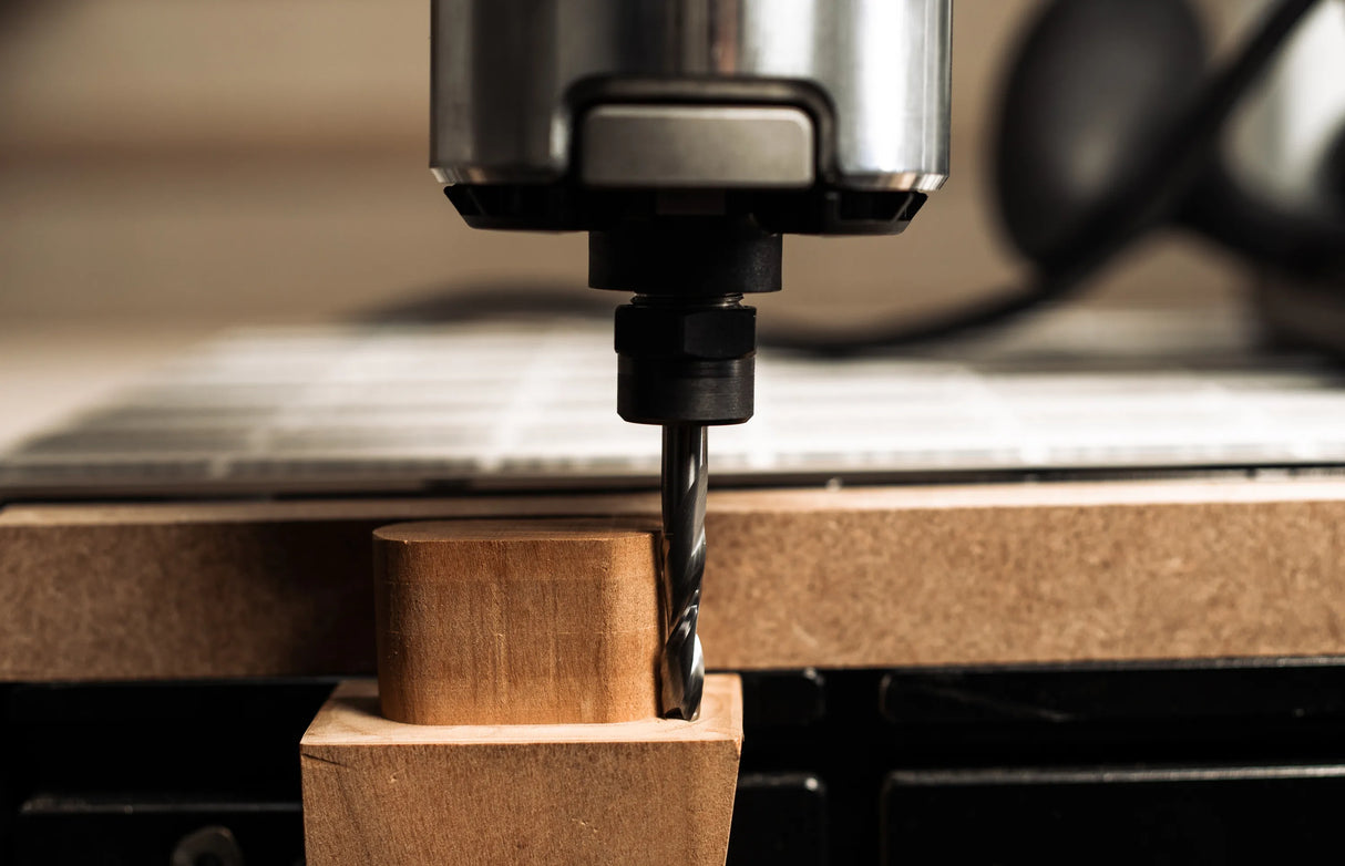 Shaper Tools 1/4in x 1in Up-Spiral Flat CNC Router Bit in use on wood surface
