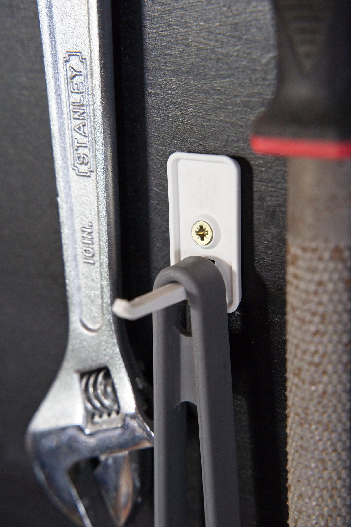 Superhooks Nimble Hook White 3 Pack 5kg Capacity hanging on wooden wall, suitable for small hand tools