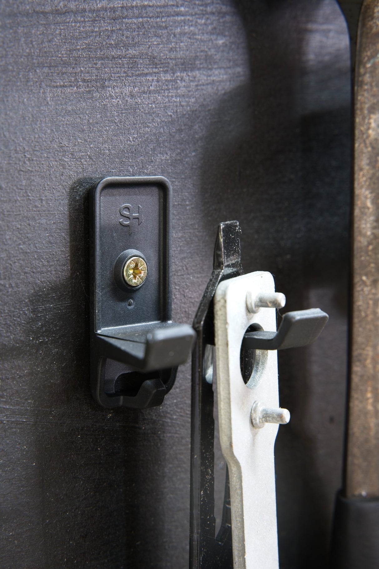 Superhooks Garage Bundle 27-Piece Black Modular Tool Wall Hooks - Detailed view of black reinforced hook in garage setting