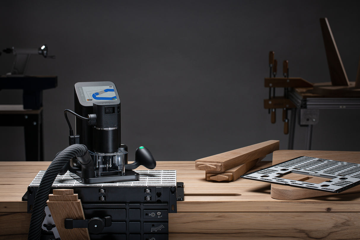 Shaper Tools Origin Handheld CNC Router in use on wood slab