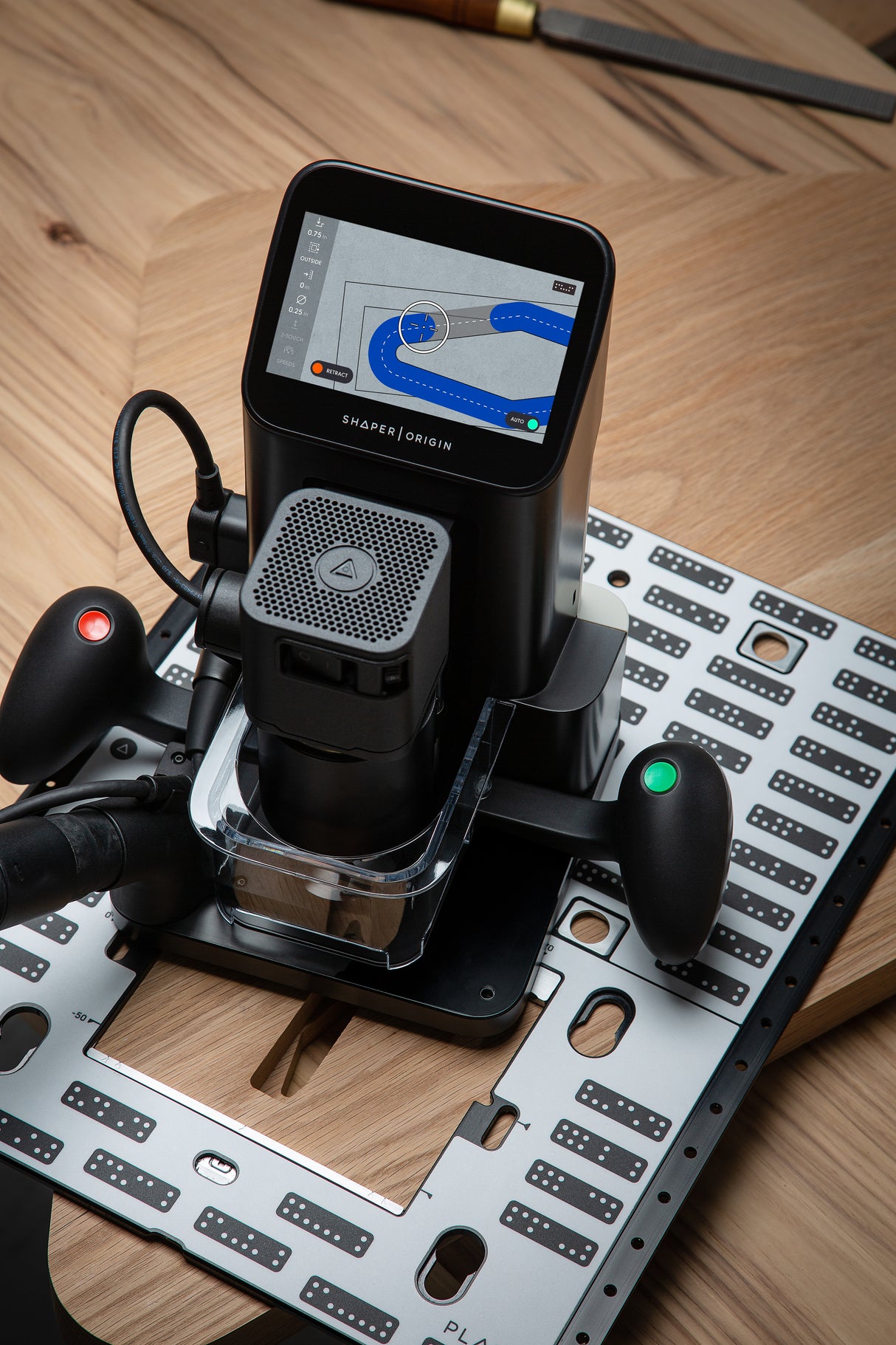 Shaper Tools Origin Handheld CNC Router with Plate Bundle in use on wood