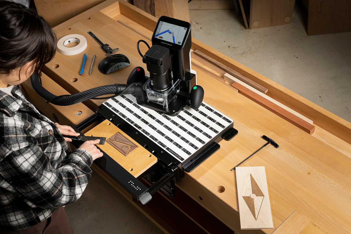 Highly versatile Shaper Workstation for Origin Handheld CNC Router in use on a woodworking bench