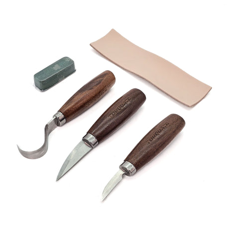 Three high-carbon carving knives in canvas roll with leather strop and sharpening compound