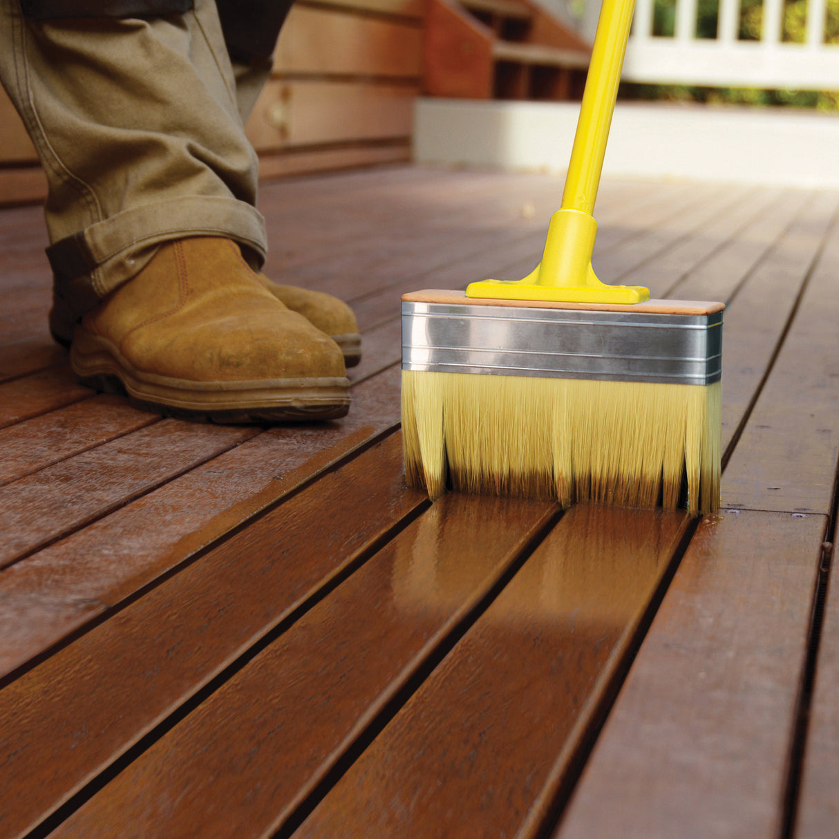 UniPro Jumbo Decking Brush applying coating between deck boards. Wide brush with long filaments, 175mm width, 50mm depth