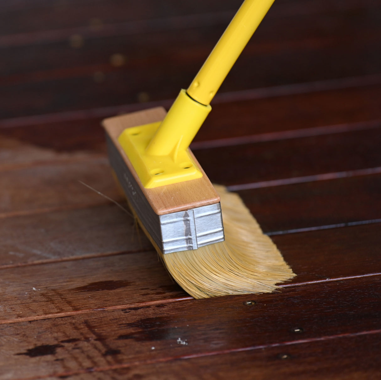 UniPro Jumbo Decking Brush 175mm Wide applying coating between deck boards