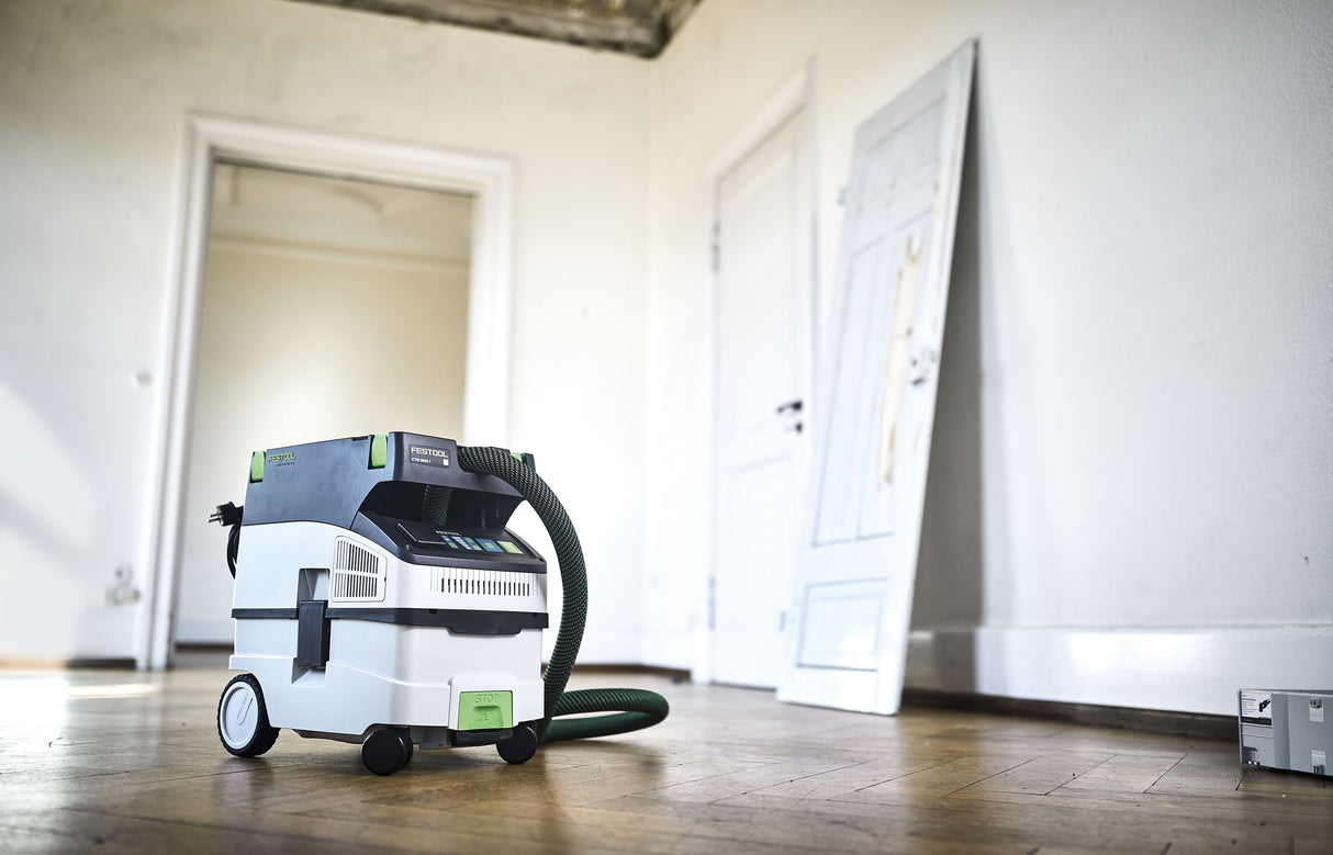 Festool CTM MIDI-I 15L M Class Dust Extractor in use with smooth suction hose and tool storage area
