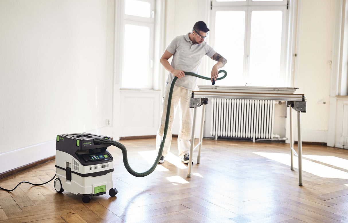 Festool CTM MIDI-I 15L M Class Dust Extractor in use with smooth suction hose and tool storage area