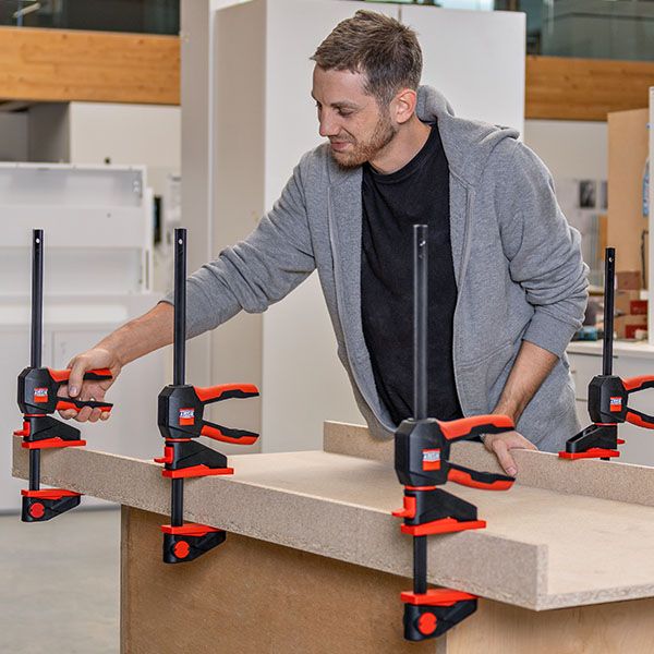 Bessey EZ360 One-Handed Clamp in action, showing innovative 360° rotating handle grip