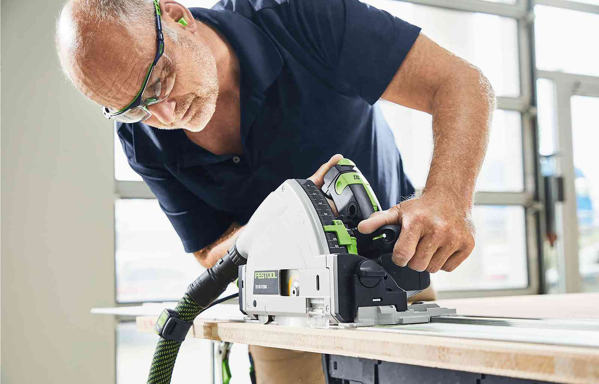 Festool TS 55F plunge cut saw in Systainer with rail on wood slab, demonstrating precision and power
