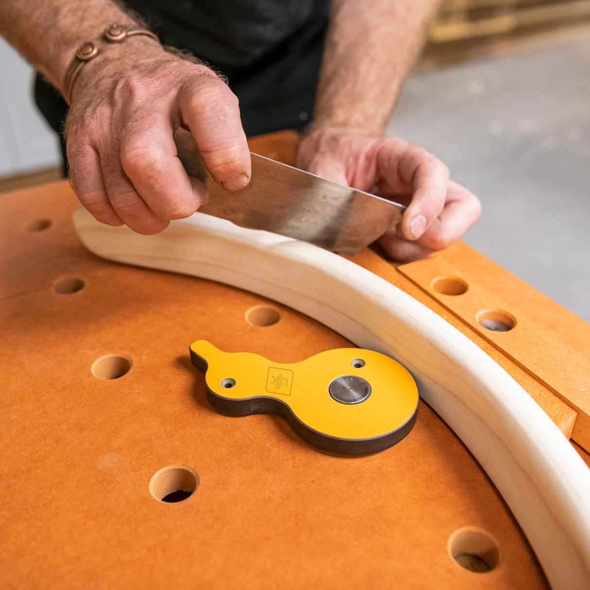 UJK Surface Cam Clamps Pack of 2 for Dog Hole Workbenches in use on a woodworking table with 20mm dog holes